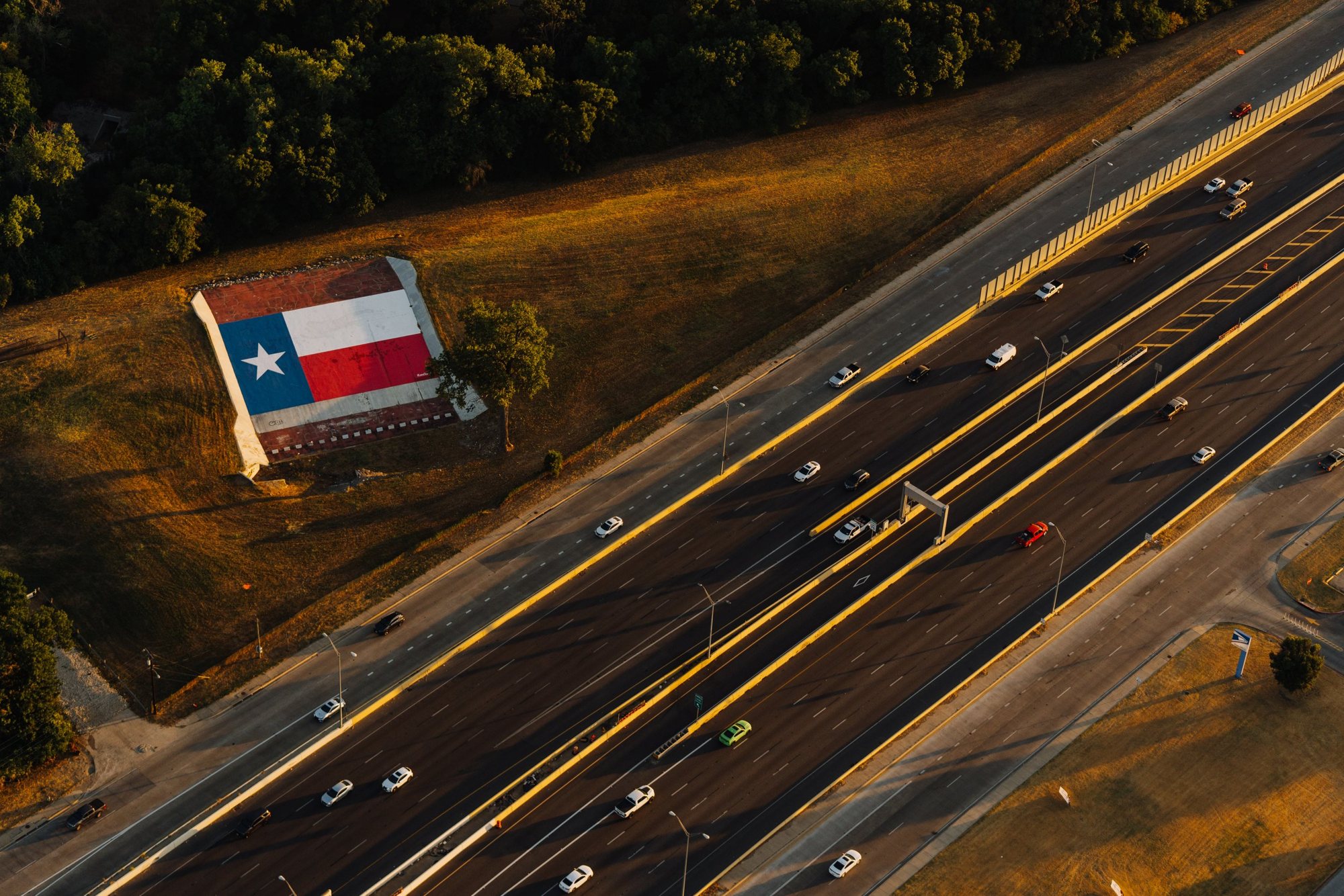 Texas flag rooftop beside the highway
